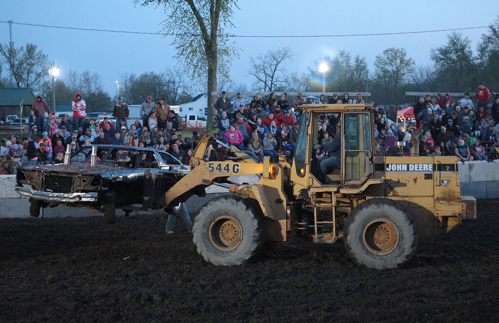 A John Deere tractor is used to remove an immobilized car